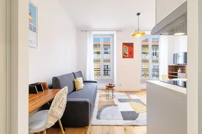 a living room with a couch and a table at Charming City Center Studio 406 in Nice