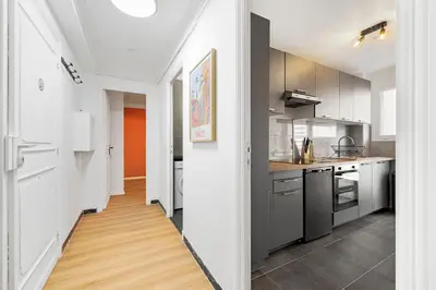 an open kitchen with stainless steel appliances and wood floors at NICE RENTING - PHILIBERT - Elegant Spacious Quiet Near the Port Free Parking in Nice
