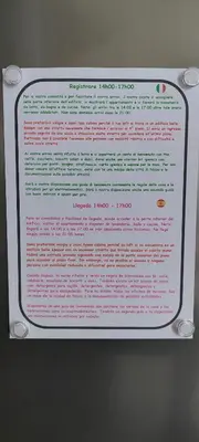 a white sign with pink writing on a wall at Loft Cosy NICE centre ville in Nice
