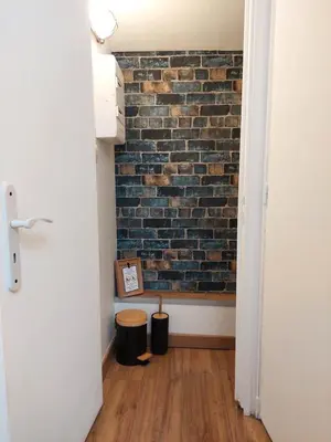 a room with a brick wall and two trash cans at Loft Cosy NICE centre ville in Nice