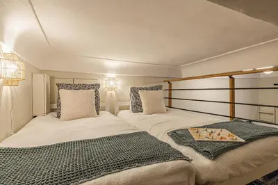 two beds in a small room with two pillows at Elegant flat with AC, heart of old Nice, Walking to the Beach! in Nice