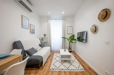 a living room with a couch and a table at Pertinax Cosy 2 pièces au coeur du centre ville de Nice AC in Nice