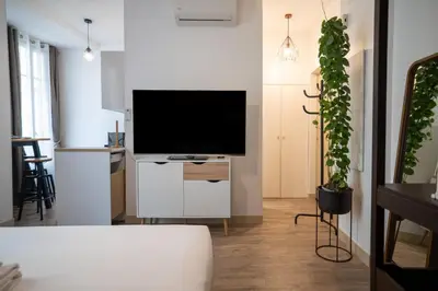 a living room with a flat screen tv at GuestReady - A peaceful stay near the marina in Nice
