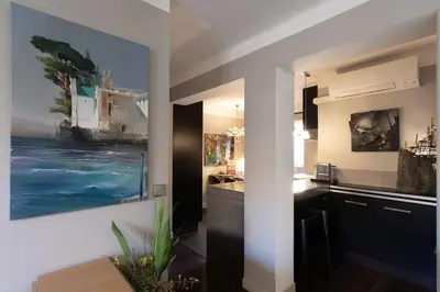 a kitchen with a large painting on the wall at #39 Old Town suite 3 BDR AC Balcony 5mins Walk to Sea in Nice