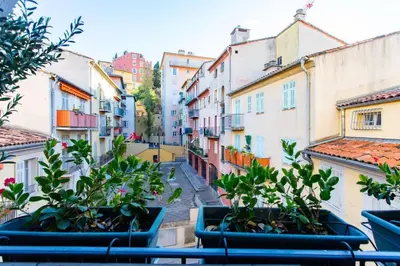a view of an alley with some plants in pots at #39 Old Town suite 3 BDR AC Balcony 5mins Walk to Sea in Nice