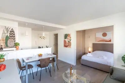 a room with a bed and a table and a kitchen at MY CASA - JOFFRE 2-4 - Bright Central 1 bedroom Near Massena in Nice