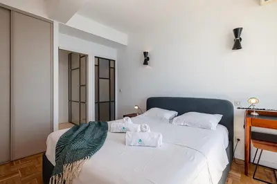 a bedroom with a white bed with towels on it at MY CASA - ETAT UNIS 93 INDIGO - Amazing Sea View Aprt with AC in Nice