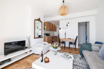 a living room with a couch and a tv at MY CASA - ETAT UNIS 93 INDIGO - Amazing Sea View Aprt with AC in Nice