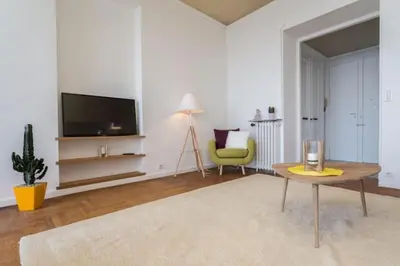 a living room with a tv and a table and a chair at MY CASA - ETATS UNIS 894 - Stunning on Sea Front w AC in Nice