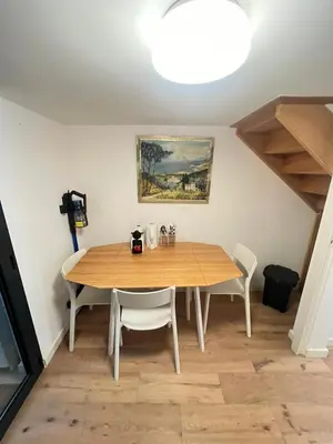a wooden table and chairs in a room at Magnifique Duplex Type Loft in Nice