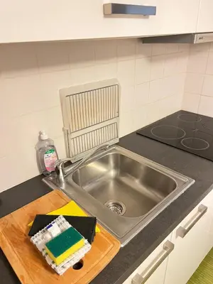 a kitchen counter with a sink and a cutting board at Magnifique Duplex Type Loft in Nice