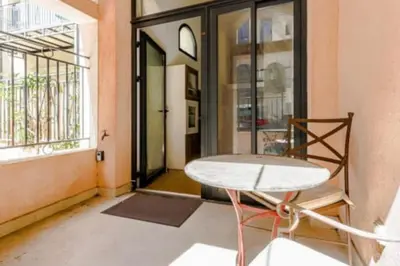 a table and a chair in a room with windows at Magnifique Duplex Type Loft in Nice