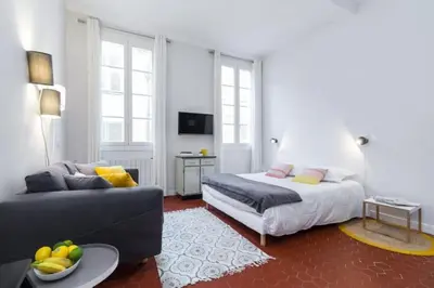 a bedroom with a bed and a couch at MY CASA - DROITE - Bright studio in the Old Town in Nice
