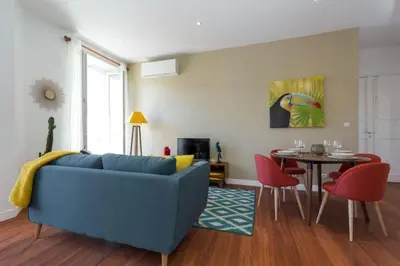 a living room with a blue couch and a table at MY CASA - GIOFFREDO 55 - 2 beds w AC on Massena Square in Nice