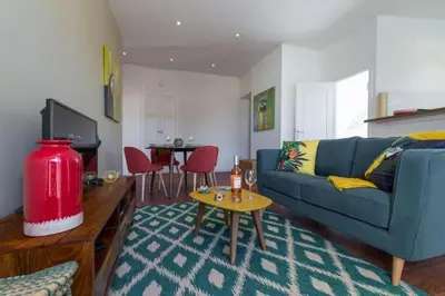 a living room with a blue couch and a table at MY CASA - GIOFFREDO 55 - 2 beds w AC on Massena Square in Nice