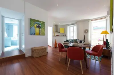 a dining room and living room with a table and chairs at MY CASA - GIOFFREDO 55 - 2 beds w AC on Massena Square in Nice