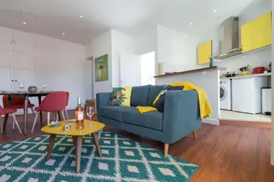 a living room with a blue couch and a table at MY CASA - GIOFFREDO 55 - 2 beds w AC on Massena Square in Nice