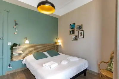 a bedroom with a bed with towels on it at MY CASA - LAMARTINE - Studio w terrace and AC Very central in Nice