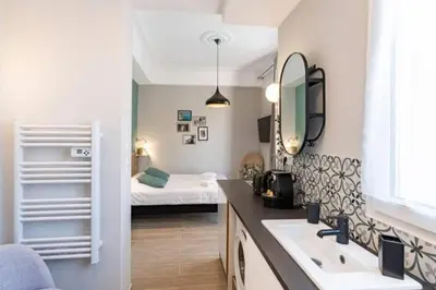 a bathroom with a sink and a bedroom with a bed at MY CASA - LAMARTINE - Studio w terrace and AC Very central in Nice