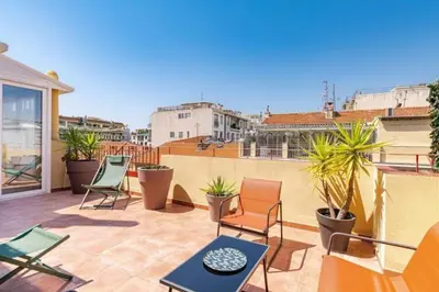 a patio with chairs and tables on a balcony at MY CASA - LAMARTINE - Studio w terrace and AC Very central in Nice