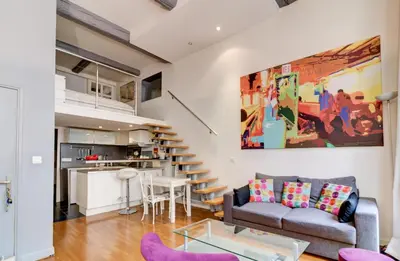 a living room with a couch and a table at Spacieux Duplex - Zone Piétonne in Nice