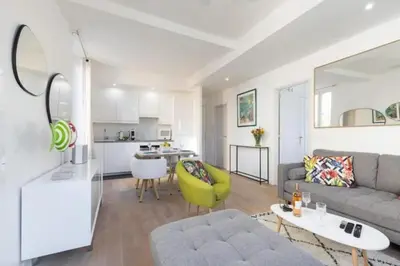 a living room with a couch and a table at MY CASA - MOULIN - Stunning 1 bedroom Apt on the Port in Nice