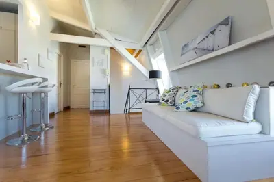 a living room with a white couch and wooden floors at MY CASA - ETATS UNIS 896 - Magic view rooftop terrace in Nice