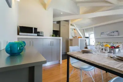 a kitchen with a table and chairs in a room at MY CASA - ETATS UNIS 896 - Magic view rooftop terrace in Nice