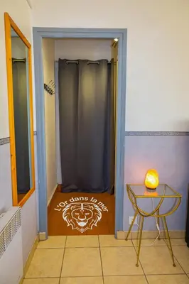 a door leading into a room with a table and a table sidx sidx at l'Or dans la Mer 3 in Nice