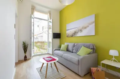 a living room with a couch and a table at MASSENA 33 - Cosy Studio City Center in Nice