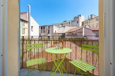 a table and two chairs on a balcony at MASSENA 33 - Cosy Studio City Center in Nice