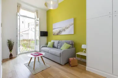 a living room with a couch and a table at MASSENA 33 - Cosy Studio City Center in Nice