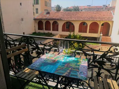 a table on a balcony with a view of a building at Hypercentre Nice Jean Medecin in Nice