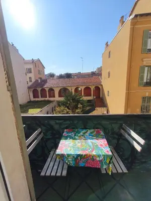a wooden table next to a bed in a room at Hypercentre Nice Jean Medecin in Nice