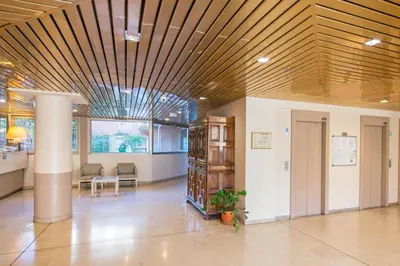 an office lobby with a wooden ceiling and a table at Appartement rénové - Terrasse - Parking - BM in Nice