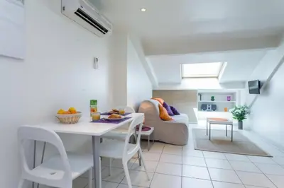 a living room with a table and a couch at MY CASA - PORT 2 - Spacious and central w AC on the Port in Nice