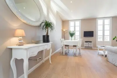 a living room with a white table and a mirror at MY CASA - JEAN JAURES - 90m2 w AC 2min to Beach in Nice