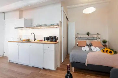 a bedroom with a bed and a kitchen with a sink at FEEL HOME - COLLET in Nice