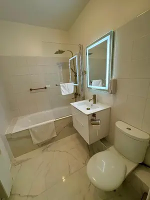 a bathroom with a toilet and a sink and a tub at L'appartement Azur in Nice