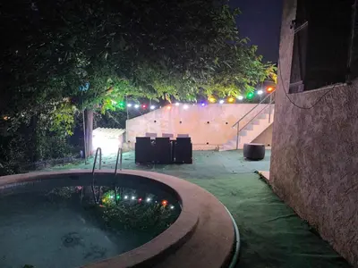 a jacuzzi tub in a backyard at night at Appartement dans villa Niçoise in Nice
