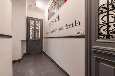 a hallway with a refrigerator in a building at Lively district - Duplex Old Town in Nice