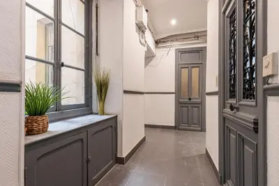 a hallway with a door and a window with plants at Lively district - Duplex Old Town in Nice