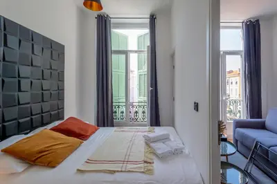 a bedroom with a large bed and a window at 301a Charming 2 rooms refurbished super center in Nice