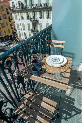 a wooden table with a plate on a balcony at 301a Charming 2 rooms refurbished super center in Nice