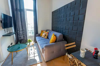 a living room with a couch and a table at 304 B Charming apartment refurbished super in Nice