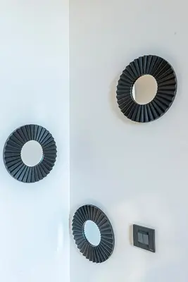two mirrors on a white wall with a mirror at 304 B Charming apartment refurbished super in Nice
