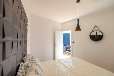 a white room with a table and a hallway at 304 B Charming apartment refurbished super in Nice