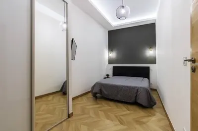 a bedroom with a bed and a sliding glass door at Joli 2 pièces au port de Nice in Nice