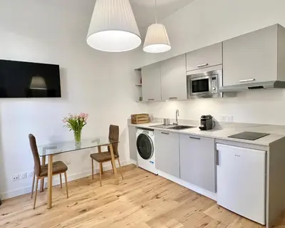 a kitchen with a table and a sink and a microwave at Confortable central Studio to discover Nice in Nice