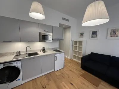 a kitchen and living room with a sink and a couch at Confortable central Studio to discover Nice in Nice